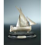 A white metal model Maltese sailing boat, stamped '800', with presentation plaque dated 1927 to