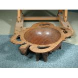 A carved hardwood tribal bowl, in the form of an upturned Turtle with fret carved border on eight