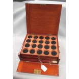An early 20th century mahogany coin tray case with hinged fall front enclosing six trays, ivorine