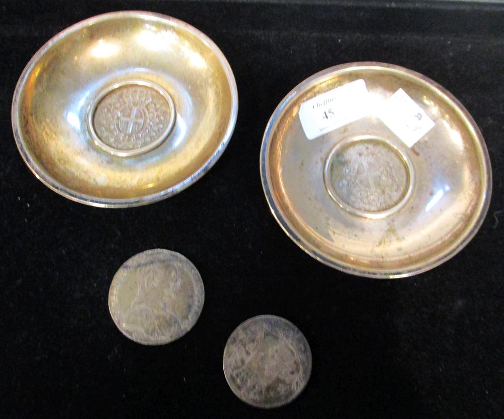 A pair of Maltese silver coin dishes inset with a 1 Scudo/ 12 Tari coin, with bust of Emmanuel de