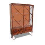 A Tortoiseshell veneered display cabinet, early 20th century with astragal glazed doors, on tapering