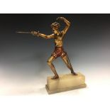 An Art Deco cold painted figure of a female fencer, standing en garde, mounted to an onyx plinth