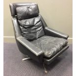 Efa, a black leather swivel lounge chair, raised on a chromed base 93 x 78cm (36 x 30in)