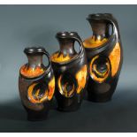 A graduated set of three German floor standing lava glazed vases, c.1960, each with integral handle,