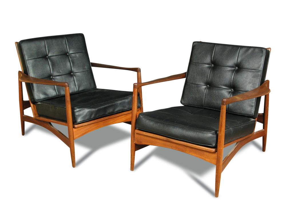 A pair of 1960's Danish teak open armchairs, with buttoned black vinyl back and seat cushions,