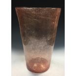 A large pink glass vase, possibly Monart, the tapering cylindrical body with bubble inclusions