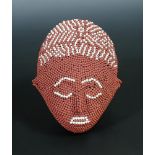 § David Mach, (Scottish, b.1956), a small matchstick head, modelled as a tribal mask in red with