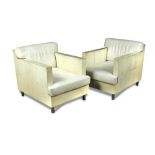 R&Y Augousti, Paris, a pair of cream vellum and white leather armchairs, raised on cylindrical legs,