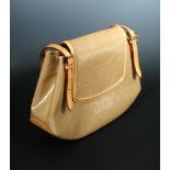 Louis Vuitton, a nude patent leather handbag, with fold over top, leather trade label to inside,