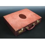 Les Must de Cartier, a maroon suede and leather briefcase, the inside lid with various