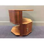 An Art Deco walnut octagonal book table, with open shelves and cupboard doors 57 x 53.50 x 53.