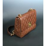 Chanel a quilted brown leather shoulder bag, stamped serial number to interior, with gilt clasp