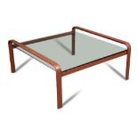 In the manner of Jacques Adnet, a glass-topped leather framed coffee table, the square plate glass