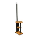 An Art Deco oak standard lamp/table, the ebonised square column above a circular top and two further