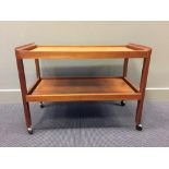 A Danish teak two-tier trolley, raised on casters 60 x 82 x 42cm (23 x 32 x 16in)