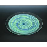 A Cenedese Murano art glass charger, of clear glass encasing green and blue swirls, signed to