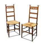 A pair of Liberty & Co. oak side chairs, the top rails pierced with spade motifs on ring turned
