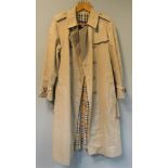 A classic Burberry ladies trench coat, the classic design with ten buttons to the front, belt and