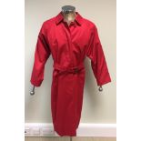 A classic Burberry ladies red trench coat, with straight button front and belt, approx. size 12