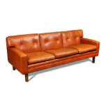 A 1960's Danish cognac leather three-seat sofa, raised on beech legs 68 x 188 x 73cm (27 x 73 x