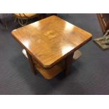 An Art Deco walnut two-tier coffee table, the rounded square top with cushion moulding 55 x 71 x
