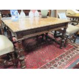 A Victorian carved oak two drawer writing table, the parquetry top on shaped legs and stretchers,