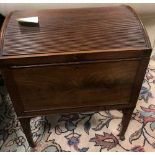 A George III mahogany dome top cellarette raised on tapering square legs with brass drop handles, 70