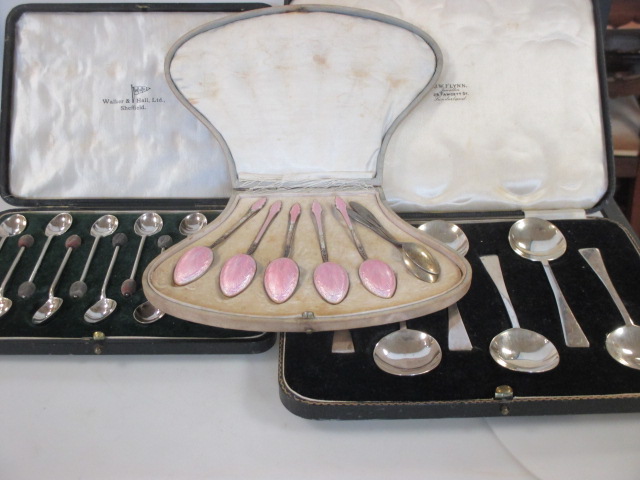 A cased set of twelve silver coffee spoons by Walker and Hall, a cased set of six silver spoons, a