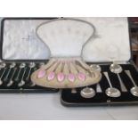 A cased set of twelve silver coffee spoons by Walker and Hall, a cased set of six silver spoons, a