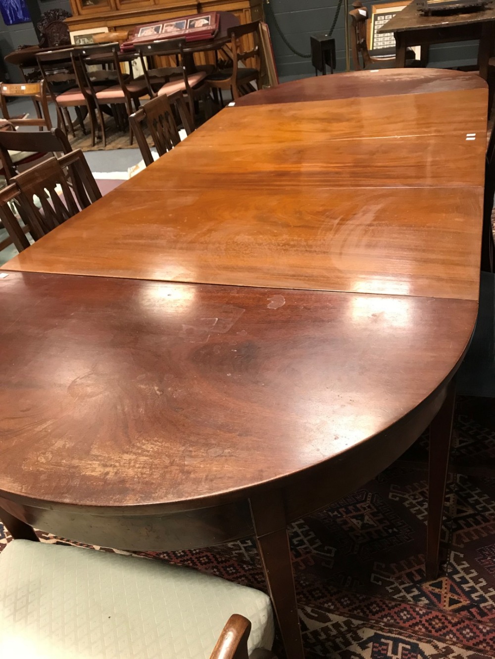 A Sheraton style mahogany D-end dining table with central drop leaf section on square tapered legs