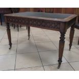 A 19th century oak Gothic library writing table with leather inset top and two frieze drawers, 75