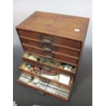 A collection of ornaments including sewing items, costume jewellery, pens etc contained in a six