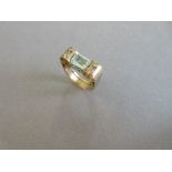 A modern craftsman made aquamarine and diamond ring, the step cut aquamarine horizontally set and