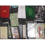 A tin of 38 Royal Mail commemorative stamp books, unused, face value over £300