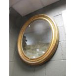 An oval gilt wall mirror 80cm high