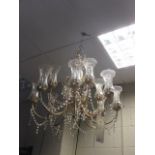 A brassed metal framed Chandelier with glass shades, approx. 58cm diameter