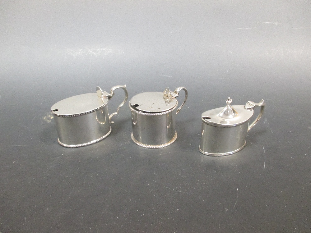 A Victorian silver mustard and two later silver mustards (3)