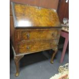 A figured walnut lady's bureau with two drawers