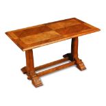 An 'Axe-man' oak coffee table, the quarter veneered rectangular top on sleigh feet united by