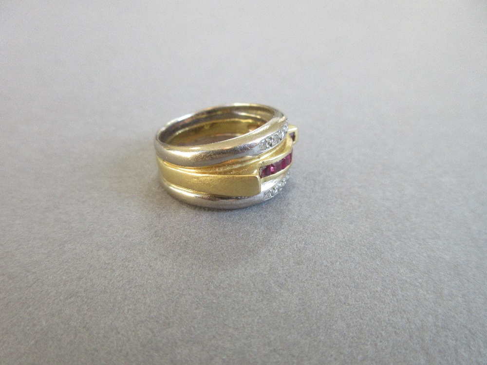 A modern ruby and diamond band ring, the central band of yellow precious metal channel set to the - Image 2 of 5