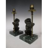 A pair of bronze and brass poodle candlesticks together with three wooden trays bearing poodles