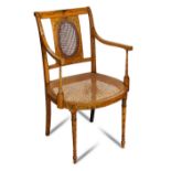 An Edwardian satinwood armchair, with floral painted frame and cane panels 90 x 45cm (35 x 18in)
