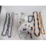 A quantity of mixed jewellery to include an amethyst pendant and matching earrings, amber bead