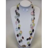 A long multi gemset and silver necklace, the mixed size oval cabochon gemstones including garnet,