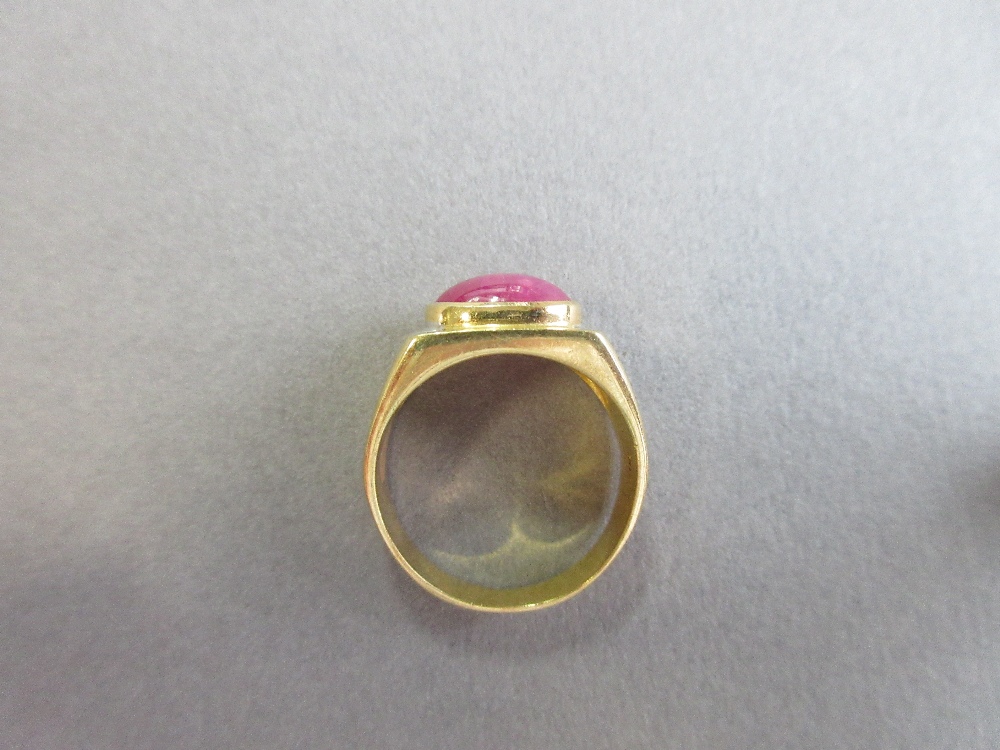 A star ruby single stone ring, the oval cabochon ruby set horizontally in a collet on a flat - Image 5 of 6