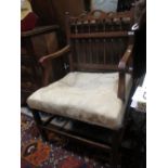 A late 19th century fruitwood elbow chair with twin baluster turned spindles to the two tier