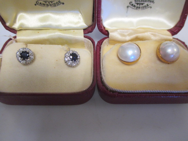 A pair of sapphire and diamond cluster earstuds set in unmarked white precious metal, total
