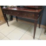 A Georgian mahogany side table with three fitted drawers on square tapered legs terminating in brass