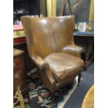 A George III style leather upholstered barrel back armchair