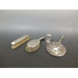 Four silver backed dressing table items
